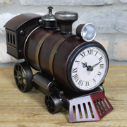 Compact novelty timepiece in the form of a steam locomotive with a snow plough, 26cm wide, 17cm tall, 11cm deep, weighing 0.8kg.