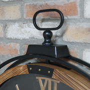 Large industrial-style wall clock featuring metal cogs and a bold black face, dimensions 88cm H x 74cm W x 9cm D, weight 7.3kg.