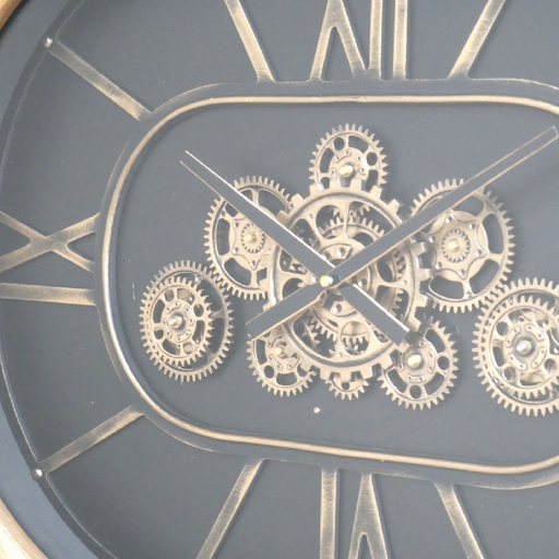 Oval wall clock with moving cogs, wood border, black dial, and gold numbers, 50cm high, 68cm wide, 8cm deep, weighing 5.6kg; requires 3 AA batteries (not included).