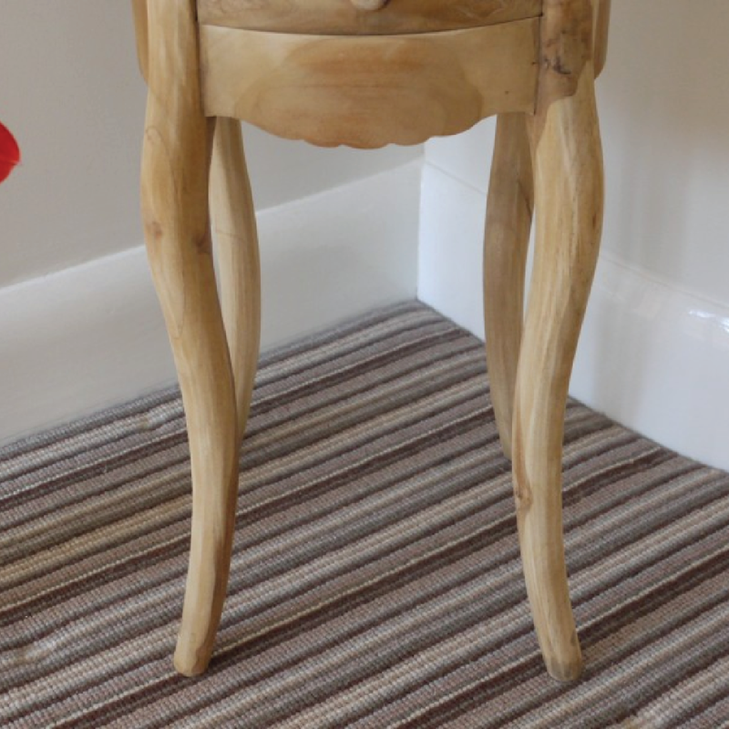 Handcrafted teak wood nightstand in raw finish, featuring a round top and organic texture, 72 × 35 × 35cm, total weight 8kg.