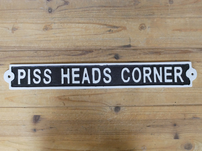 SIGN PISS HEADS CORNER