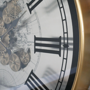 Industrial-style white clock with exposed moving cogs and black Roman numerals, 80cm in diameter and 10cm deep, 10.8kg in weight; operates on 3 AA batteries (not included).