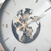 Stylish circular clock showcasing a global map, silver dial with gold text, and mechanical cogs, 60cm in diameter and 8cm deep, 5kg in weight.
