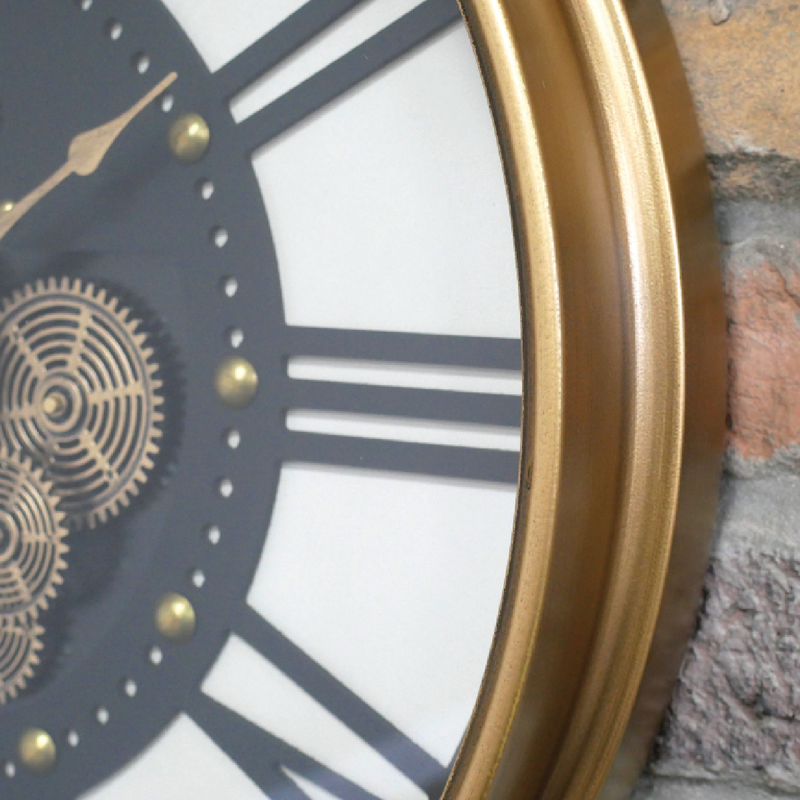 Industrial-style round clock with classic Roman numerals and functional-looking gold or metal cogs, 54cm in diameter, 8cm deep, 4.5kg in weight.