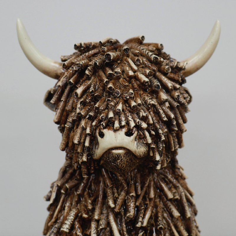 Decorative figurine of a seated cow with smooth or textured finish, dimensions 25cm H × 16cm W × 19cm D, weight 1.25kg.