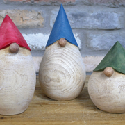 Festive decorative gonks crafted to resemble wood, 0.75kg in weight, perfect for adding cozy charm to mantels or shelves during the Christmas season.