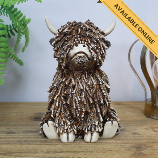 Highland cow sitting medium ornament. A unique and stylish piece, perfect for modern or rustic interiors, 18cm high, 12cm wide, 13cm deep, weighs 0.83kgs.