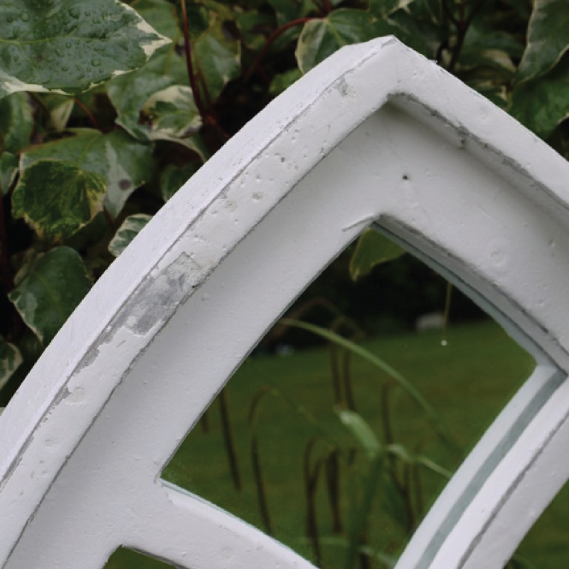 Decorative arched mirror in a smooth white frame, 62cm tall by 55cm wide by 4cm deep, 3.75kg in weight.