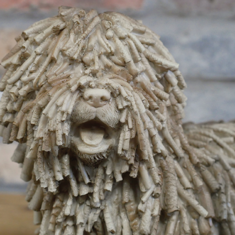 Stylish figurine of a shaggy dog with textured detailing, dimensions 23cm H × 27cm W × 13cm D, weight 0.92kg.