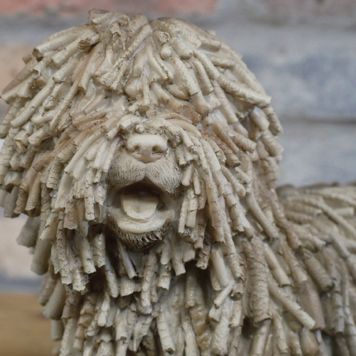 Stylish figurine of a shaggy dog with textured detailing, dimensions 23cm H × 27cm W × 13cm D, weight 0.92kg.