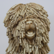 Decorative figurine of a seated shaggy dog with textured fur detailing, dimensions 26cm H × 16cm W × 21cm D, weight 1.25kg.