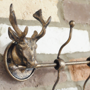 Decorative stag head coat rack featuring several functional hooks, dimensions 22cm H × 50cm W × 9cm D, weight 1.5kg.