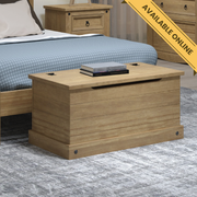 Solid pine storage trunk with a hinged lid, perfect for blankets, linens, or toys, 44.5cm high, 90.2cm wide, 48cm deep, weighing 15.5kg, featuring rustic charm.