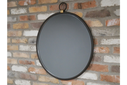 A sleek round mirror with a thin black frame and subtle gold accents, offering a modern and elegant look.