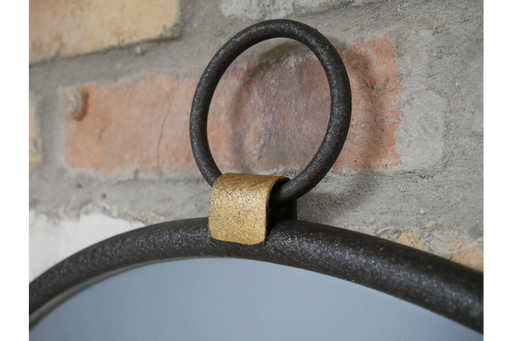 Contemporary round wall mirror featuring a minimalist black bezel highlighted with refined gold detailing.